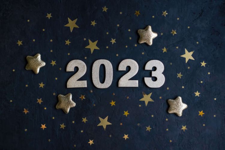 Golden numbers 2023 with gold stars on a dark background. New Year greeting card